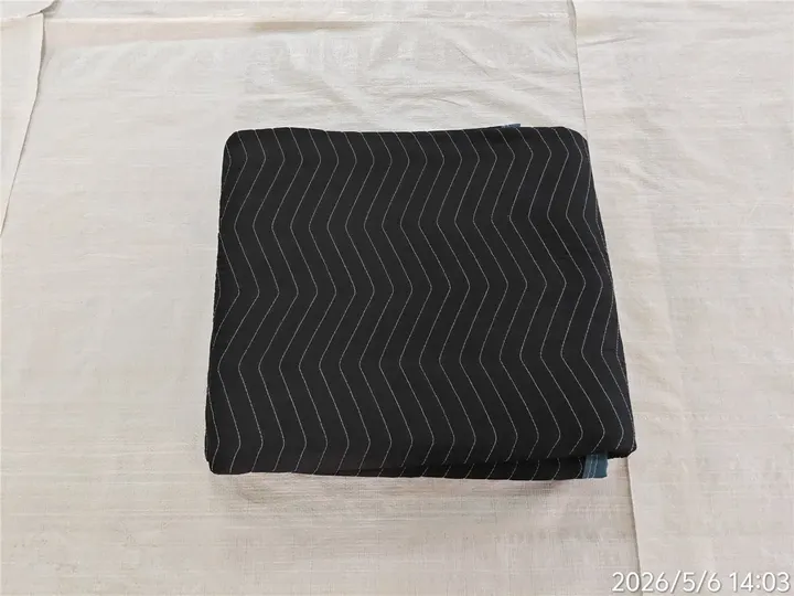 Folded black polyester moving pad with blue trim