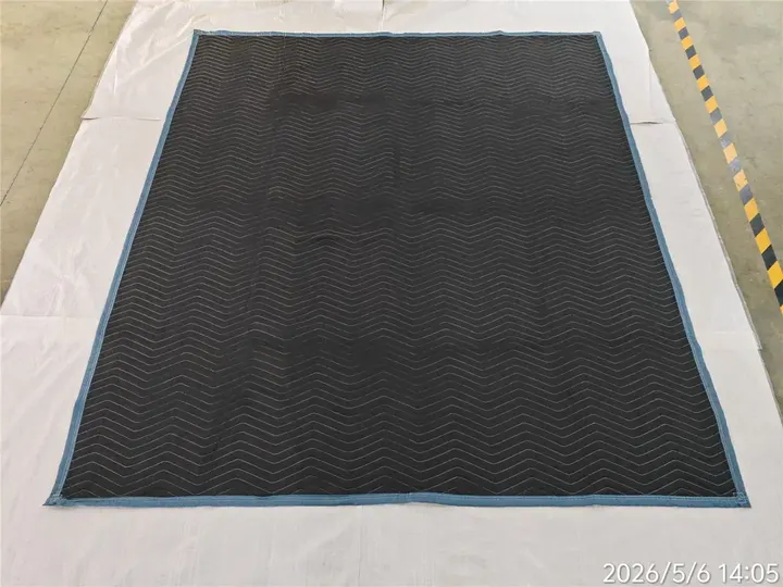 Black polyester moving pad laid flat with blue trim
