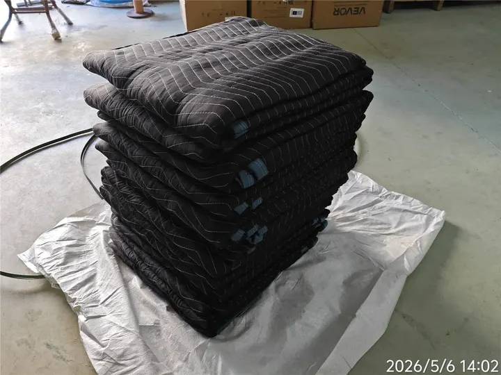 Stack of folded black polyester moving pads