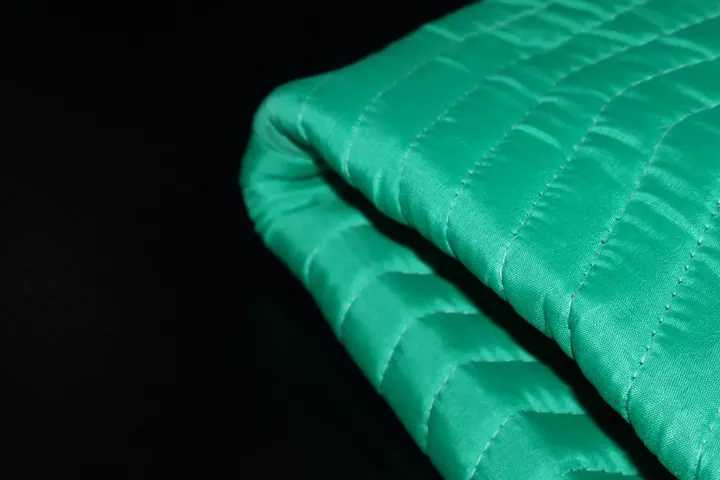 Folded green polyester moving pad edge detail