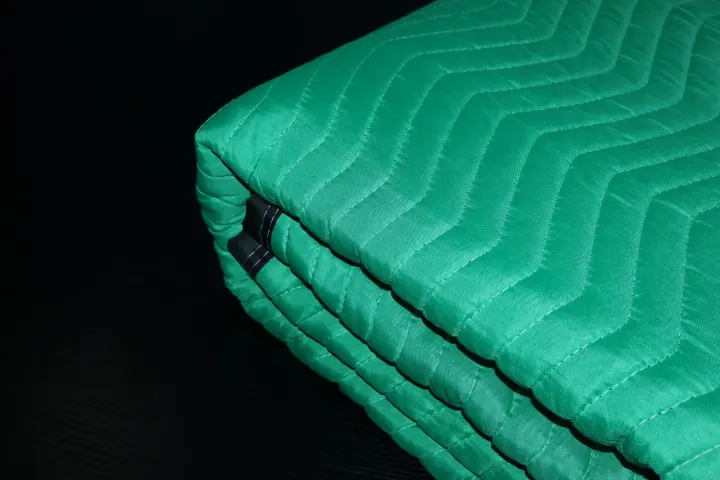 Folded stack of green polyester moving pads