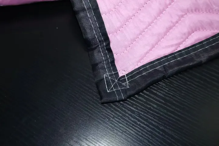 Pink polyester moving pad corner with black trim