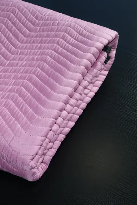 Folded pink polyester moving pad edge