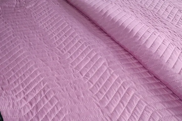 Pink polyester moving pad quilted stitching close-up