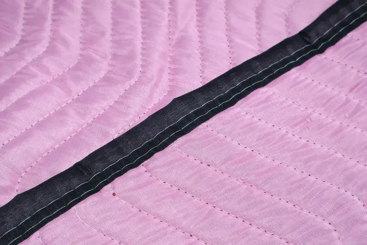 Pink polyester moving pad quilting and black trim