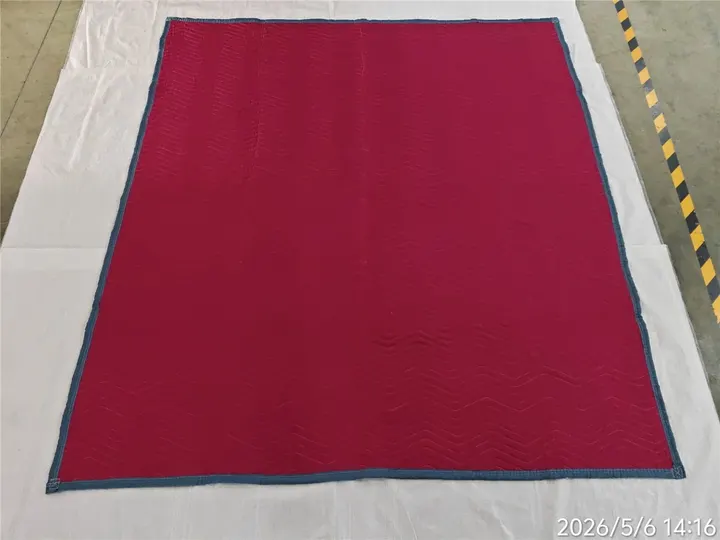 Red polyester moving pad laid flat with blue trim
