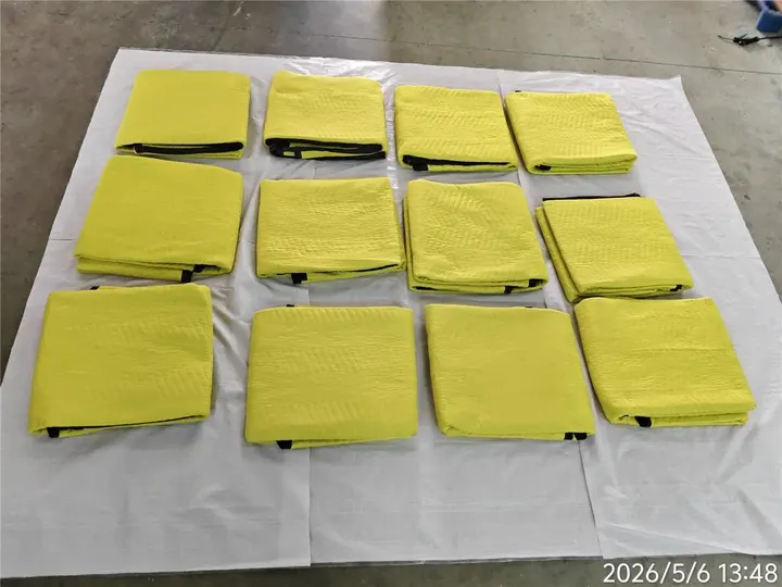 Multiple folded yellow polyester moving pads laid out together
