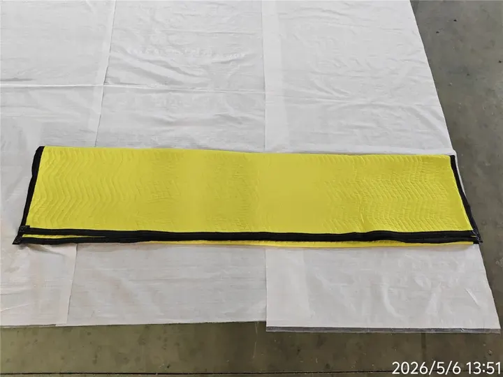 Yellow polyester moving pad folded lengthwise with black trim