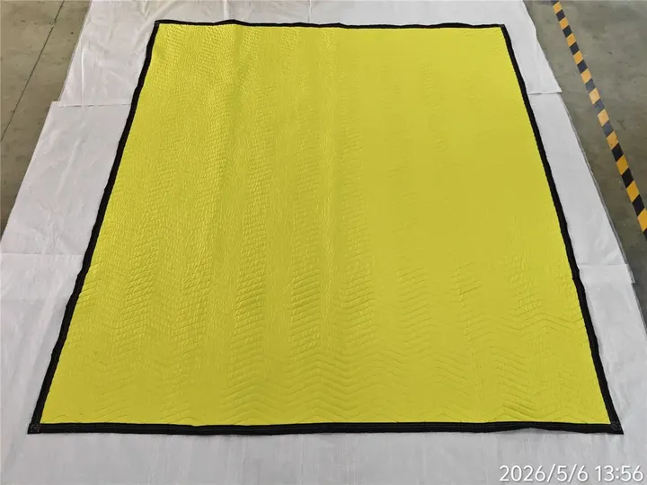 Yellow polyester moving pad laid flat with black trim
