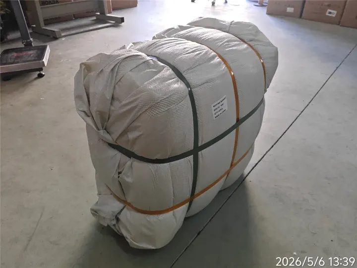 Packed bale of moving blankets strapped for bulk handling